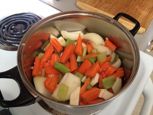 Chopped and peeled carrots, chopped celery, and quartered onions for the broth