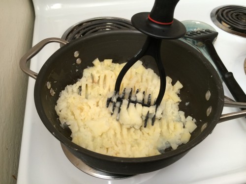 Mashing the potatoes, parsnips, and butter