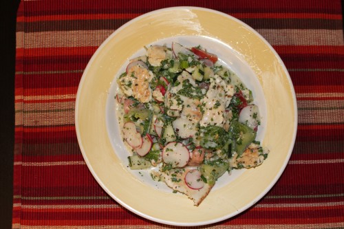 Fattoush - middle eastern salad with tomatoes, cucumbers, radishes, pita, buttermilk, and herbs