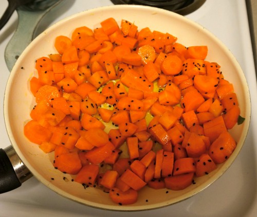 carrots sauteeing in olive oil with caraway seeds