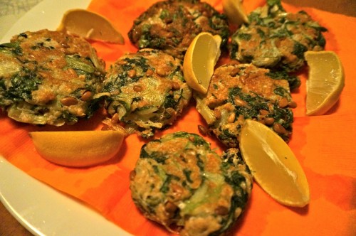 Chard cakes with lemon wedges and halloween napkins 