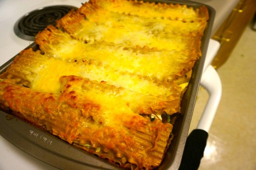 Mushroom lasagna topped with shredded mozzarella and parmesan