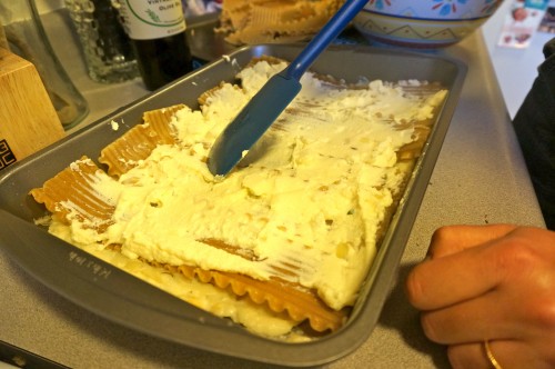 Spreading the ricotta/feta/egg mixture on top of the lasagna noodles