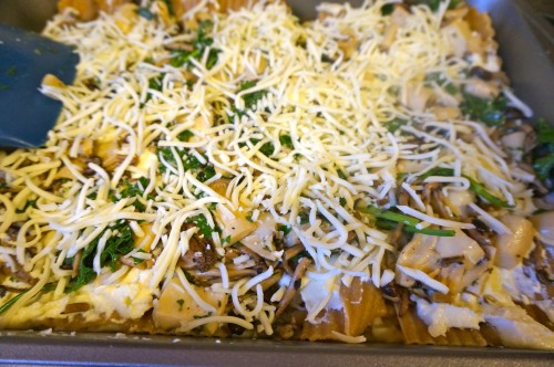 Lasagna noodles layered with ricotta/egg/feta mixture, mushrooms and herbs, and shredded mozzarella