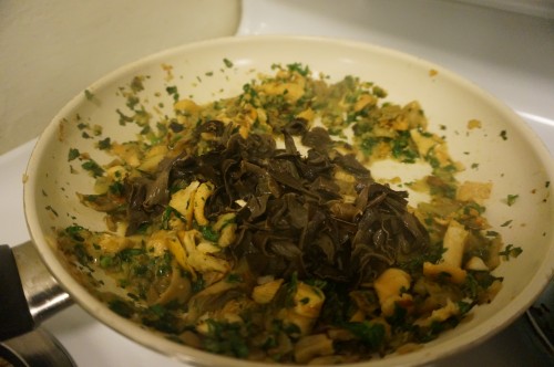 Shallots, garlic, parsley, celery, hedgehogs, chanterelles, and black trumpets sauteeing