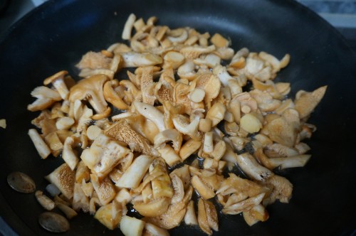 Hedgehog mushrooms cleaned and cut in a heated pan