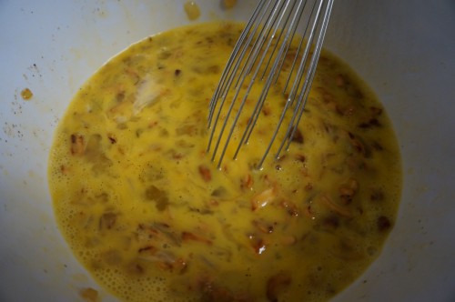 Whisking together the onions, mushrooms, and eggs for the frittata